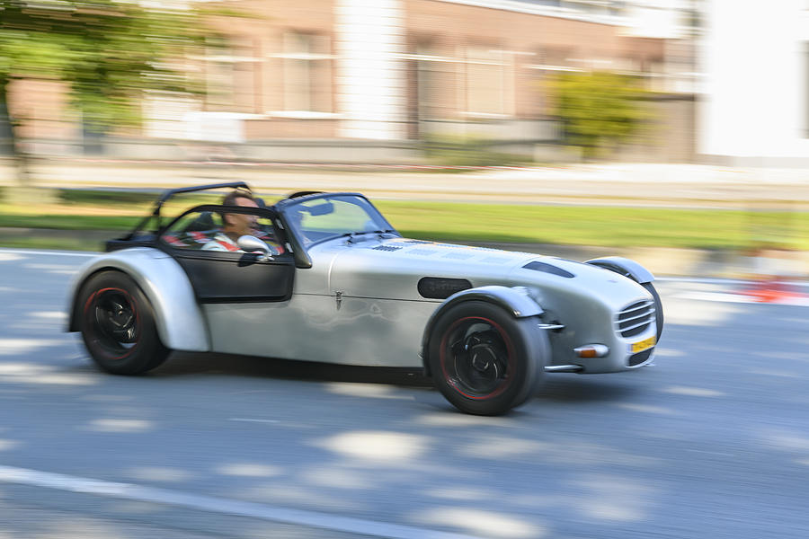 Donkervoort lightweight Dutch sports car driving at high speed on a road through a forest Photograph by Sjo
