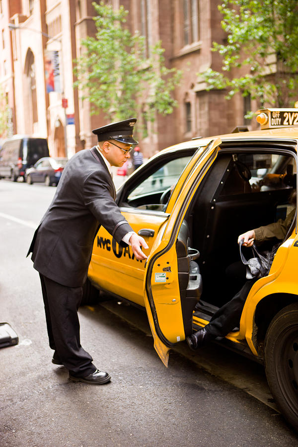 DoorMan opening taxi arriving at New York Hotel Photograph by Anouchka