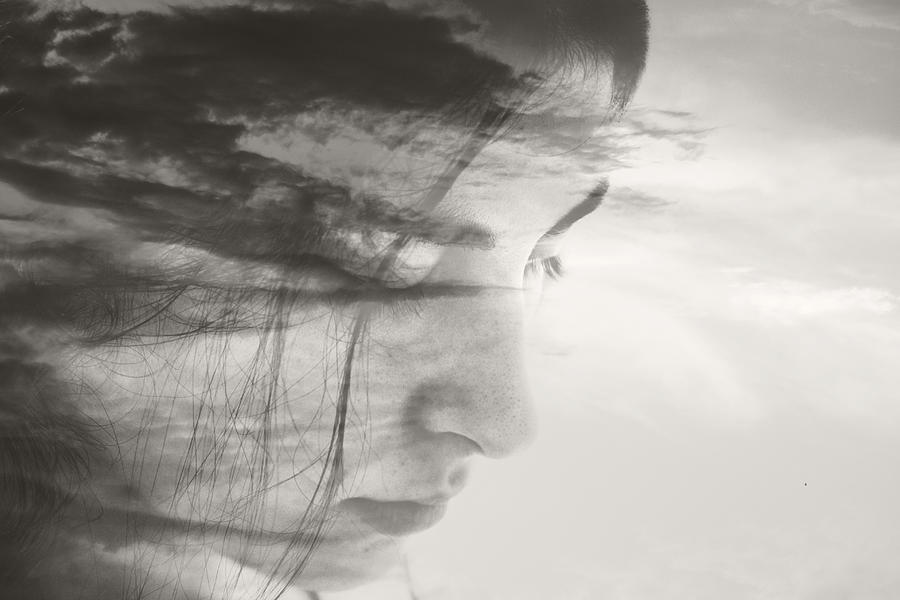 Double exposure of a young womans face and clouds Photograph by Owl Stories