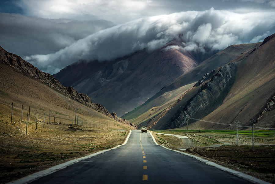 Dramatic cloud over mountain in TIbet Photograph by Coolbiere Photograph