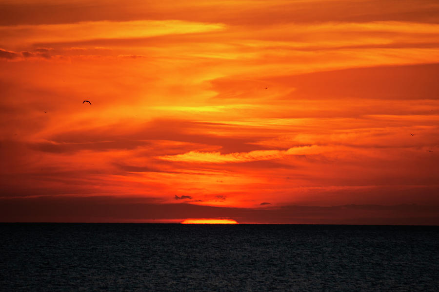 Dramatic orange and red sunset over the Gulf of Mexico Photograph by ...