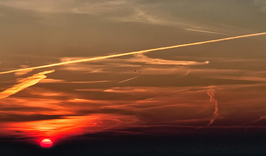 Dramatic sky at sunrise sun at the left Photograph by Jean-Marc PAYET