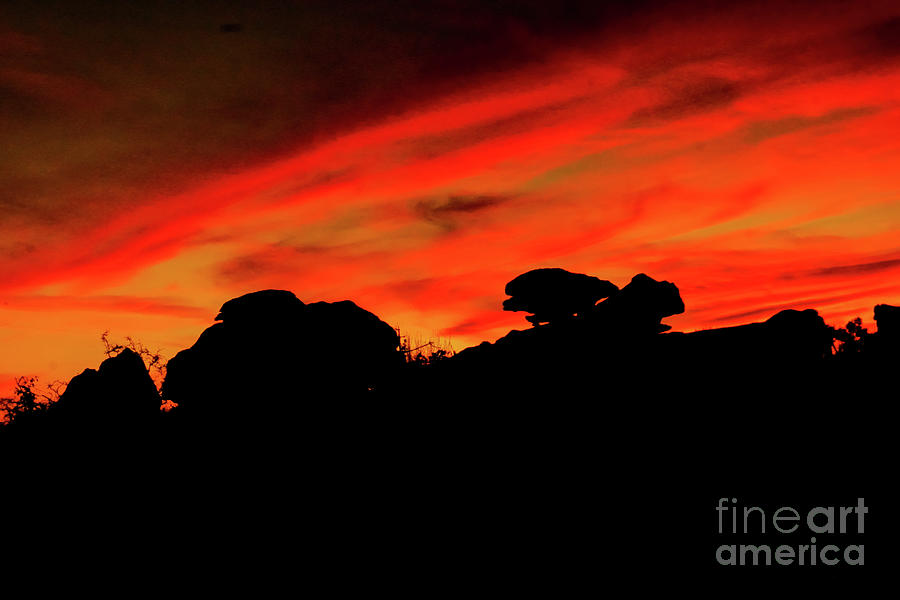 Dramatic sundown and rock silhouettes  Photograph by Jeff Swan