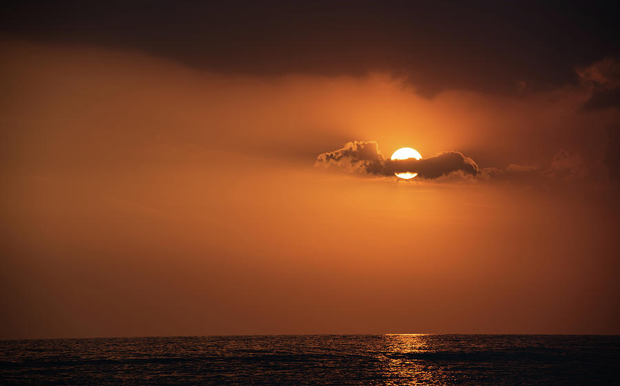 Dramatic sunset over the ocean. Cloudy and orange sky. Beautiful end of day Photograph by Michalakis Ppalis