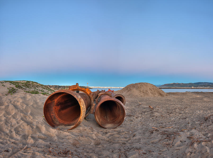 Dredge pipes lying on the beach ready for assembly. Photograph by Motionshooter