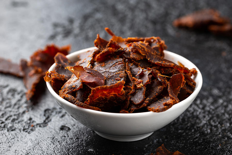 Dried Beef Jerky snack in white bowl Photograph by DronG