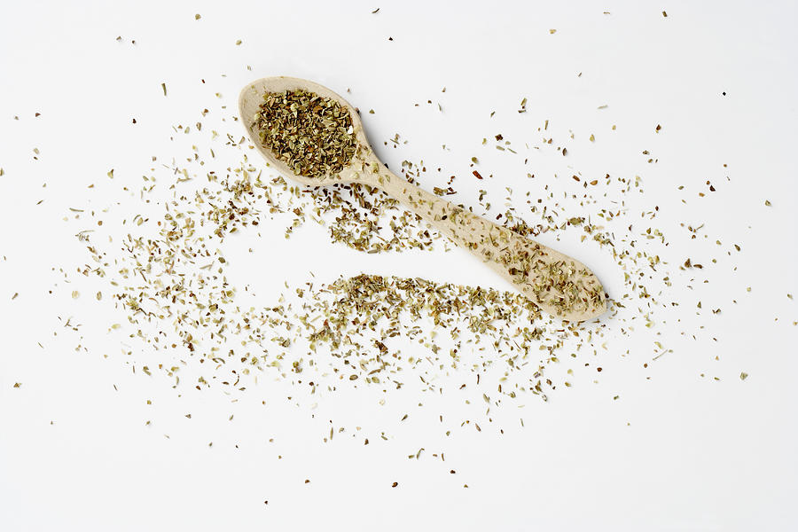 Dried oregano spread around spoon Photograph by Image Professionals GmbH