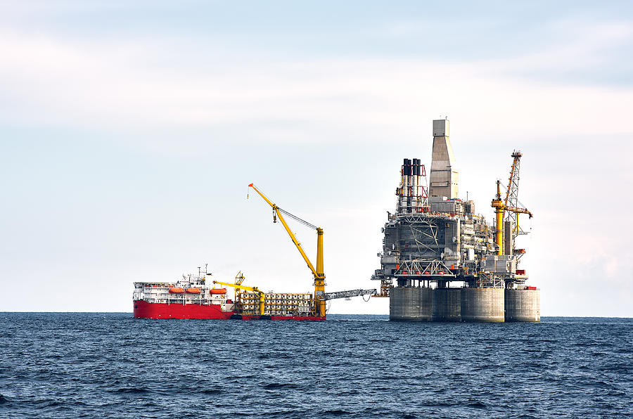 Drilling rig and support vessel on offshore area Photograph by Sergei Dubrovskii