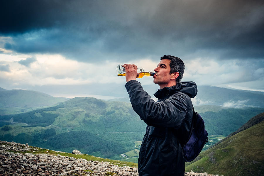 Drinking Scotch from the bottle on Ben Nevis Photograph by © Peter Lourenco