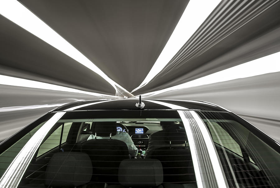 driving black German car with reflections and the rear window in foreground - tunnel Photograph by Emanuel M Schwermer