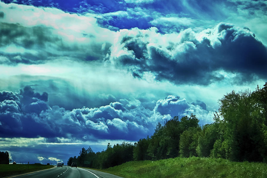 Driving under a stormy sky Photograph by Tatiana Travelways