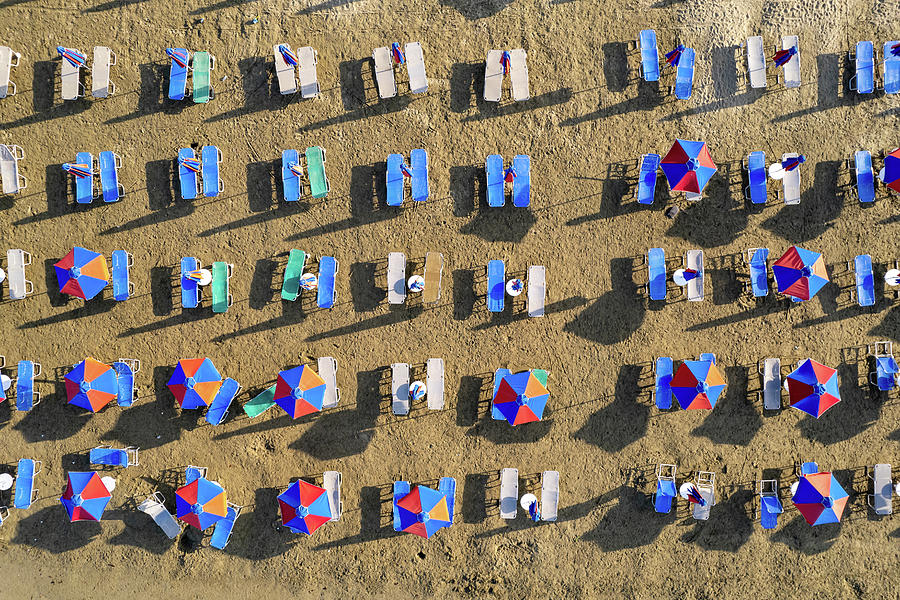 Drone aerial of beach umbrellas in a sandy coast. Summer holidays Photograph by Michalakis Ppalis