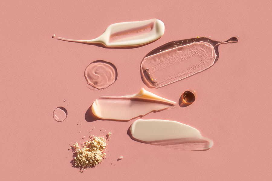 Drops and smears of various cosmetic products on pink background. Trendy selfcare products of the year Photograph by Anna Efetova