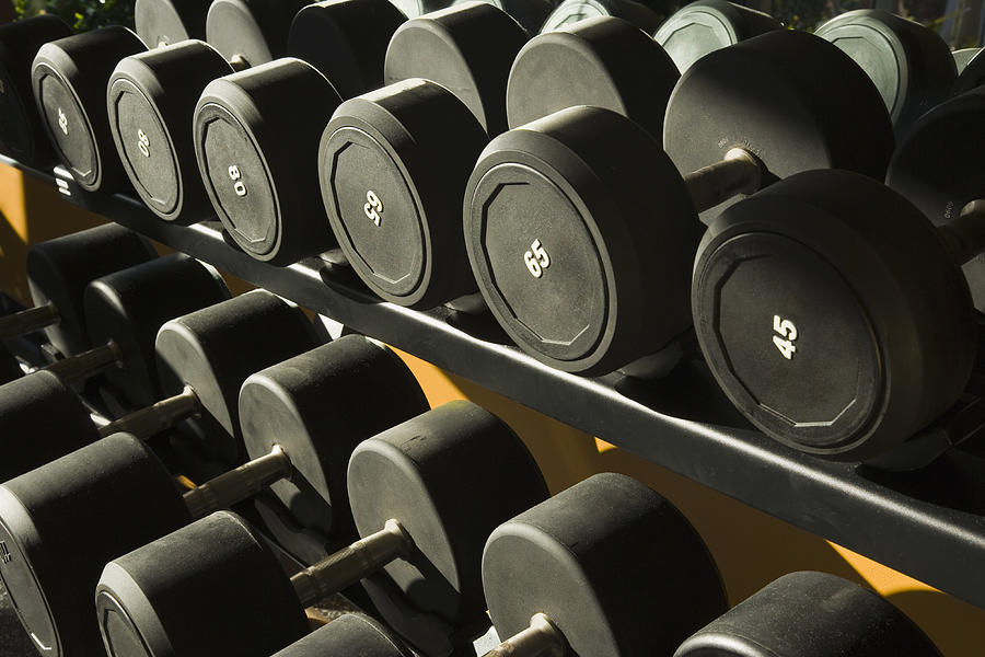 Dumbbells on a metal rack in gym, Close-Up Photograph by Juan Silva