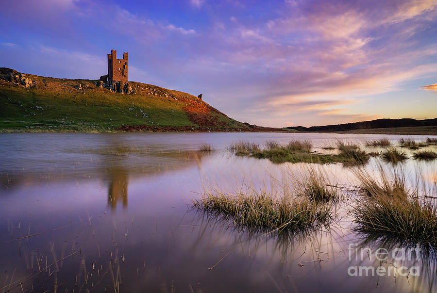 Dunstanburgh Castle reflections at sunset Embleton Bay, Northumberland, England  Photograph by Neale And Judith Clark