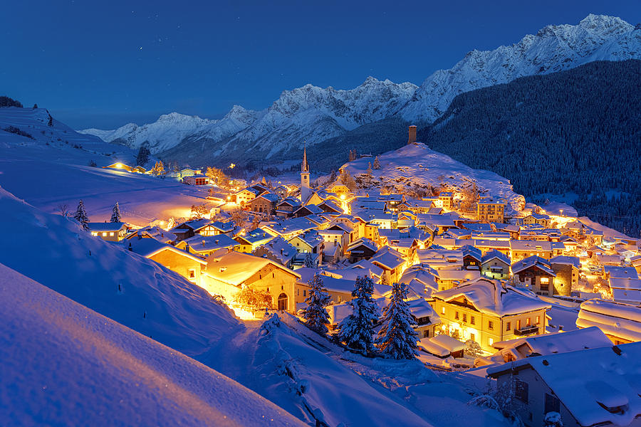 Dusk on Ardez village covered with snow, Switzerland Photograph by Roberto Moiola / Sysaworld