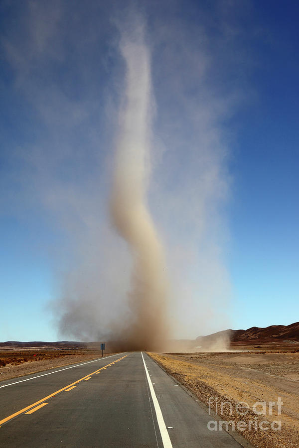 Dust devil crossing the road Bolivia Photograph by James Brunker