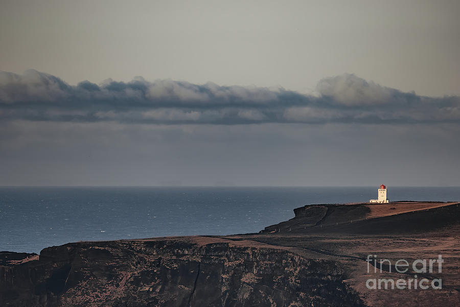 Dyrholaey Lighthouse stands on the rugged cliffs of the Southern iceland. Sea view in autumn with the Atlantic Ocean beyond Photograph by Jane Rix