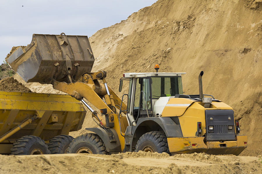 Earth Mover loading ground to the dump truck Photograph by ewg3D