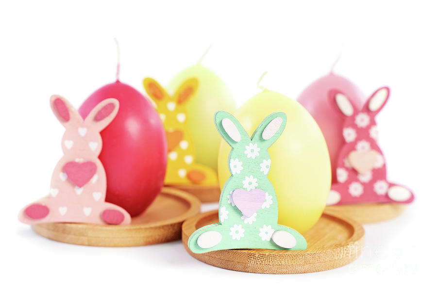 Easter Bunnies next to egg shaped candles Photograph by Mendelex Photography