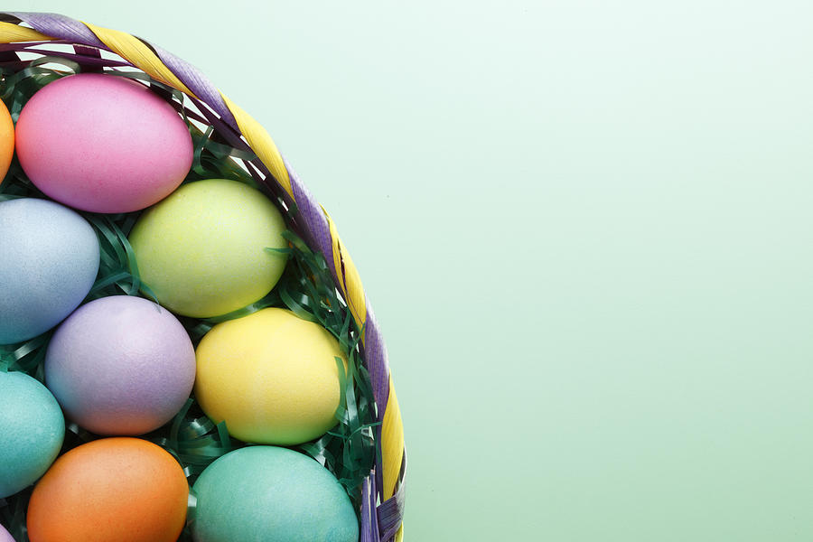 Easter eggs in Easter basket on green background Photograph by Dny59