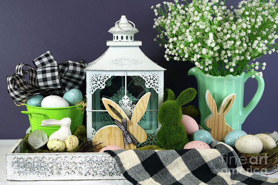 Easter farmhouse vignette with bunnies, Easter eggs and buffalo plaid check. Photograph by Milleflore Images