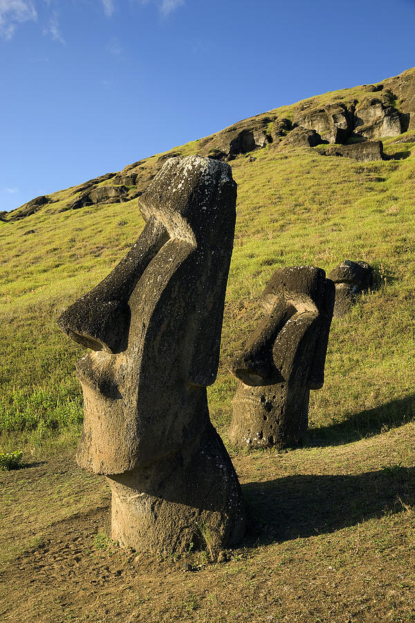 Easter Island, Rano Raraka, two ancient Moai statues on hillside Photograph by Michael Dunning