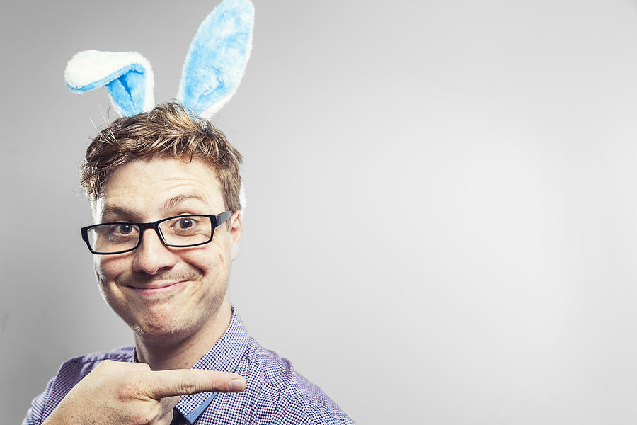 Easter nerd with rabbit ears in a photography studio Photograph by Benstevens