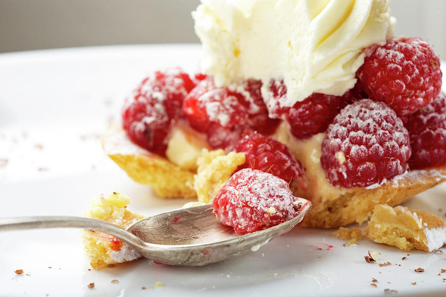 Eating from a baked cake with raspberries  Photograph by Sebastian Radu