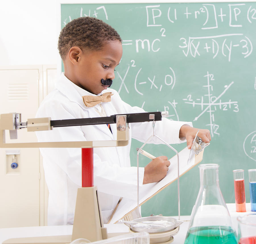 Education: African descent boy scientist in his lab doing experiments. Photograph by Fstop123