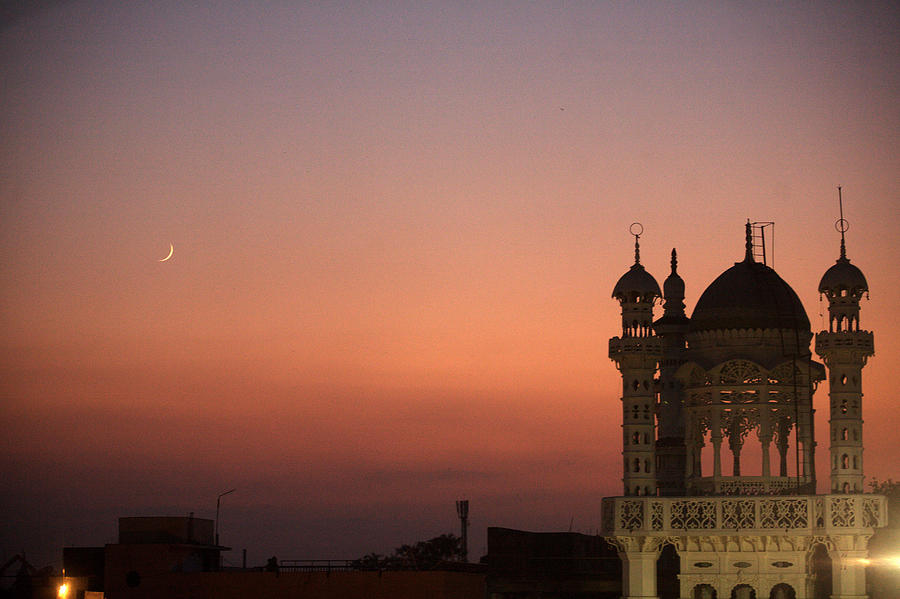 Eid-al-Fitr moon in sky and beautifully lit tomb of Masjid in textile town of Malegaon, Maharashtra, India Photograph by Dinodia Photo