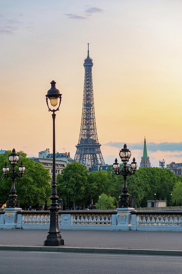 Eiffel tower and lamppost with orange sky Photograph by Philippe Lejeanvre