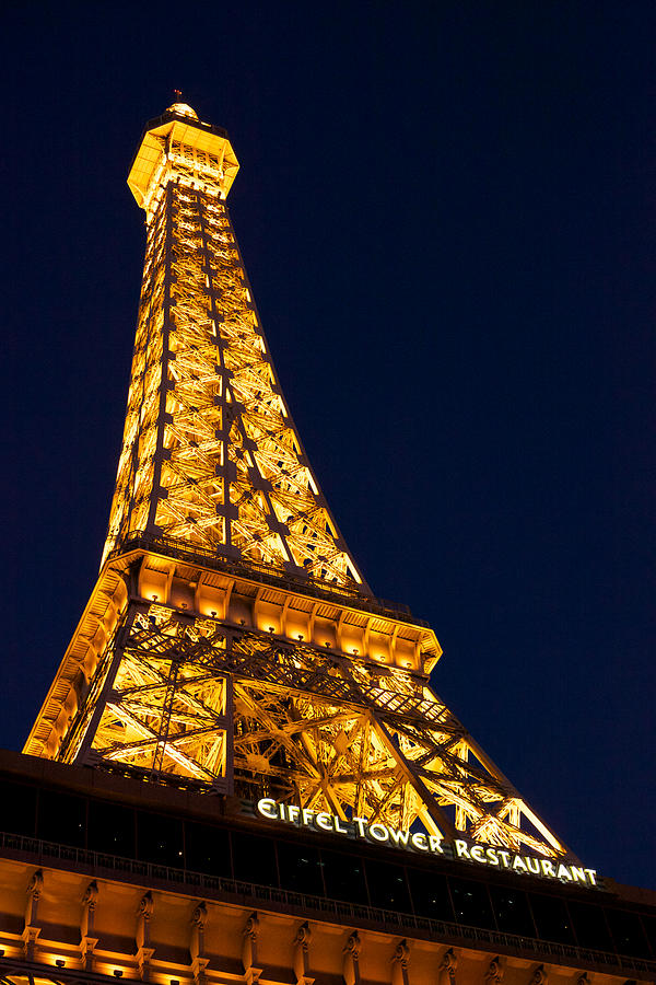 Eiffel Tower Restaurant at Paris hotel and casino on the Las Vegas Strip at night Photograph by Mark Meredith
