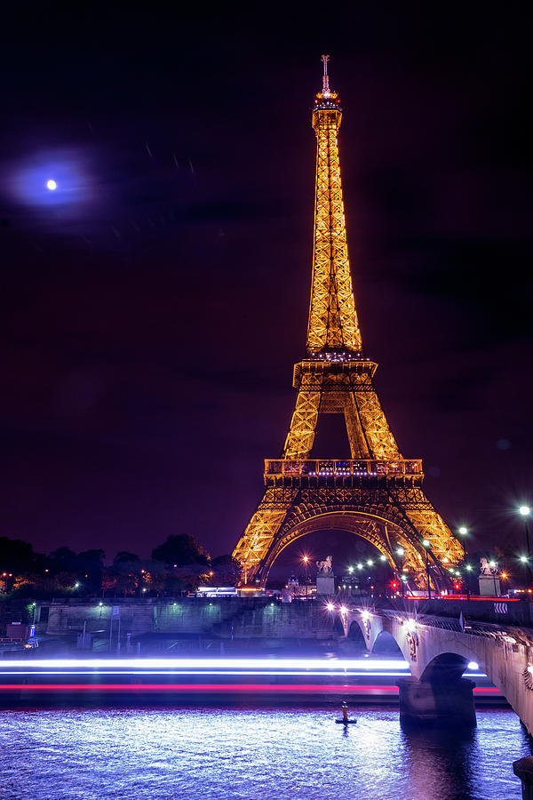 Eiffle tower and the moon in Paris by Andrew Lalchan