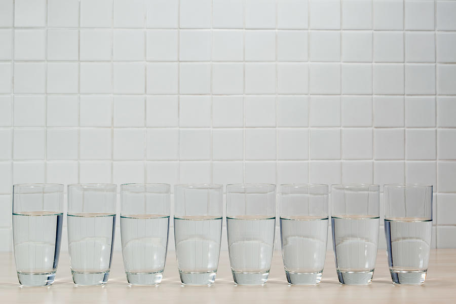 Eight glasses of mineral water Photograph by Image Source