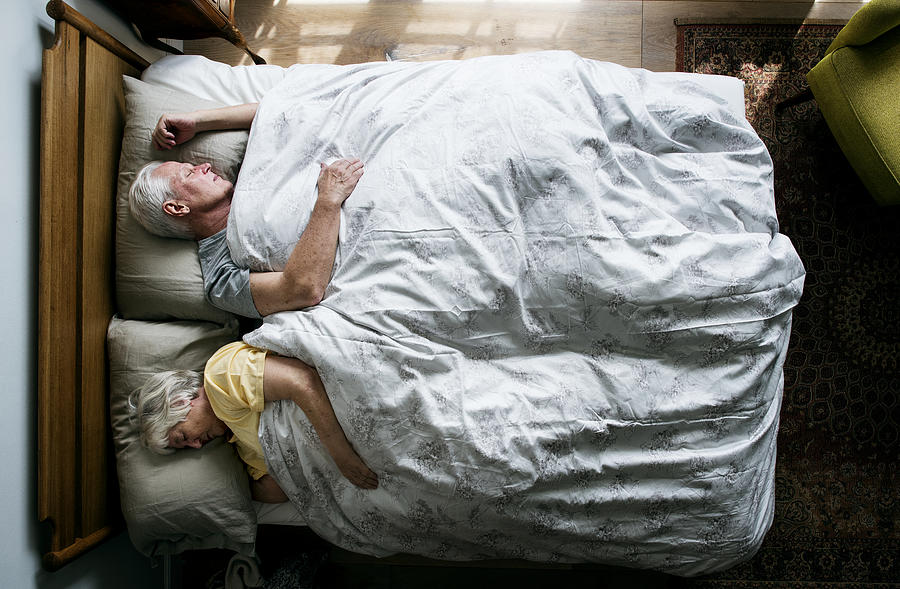 Elderly Caucasian couple sleeping on the bed Photograph by Rawpixel