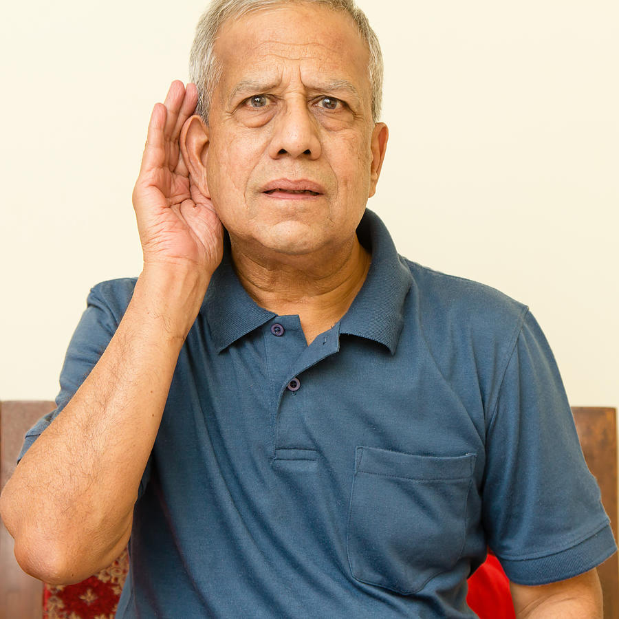 Elderly Indian man has hearing difficulty Photograph by VasukiRao