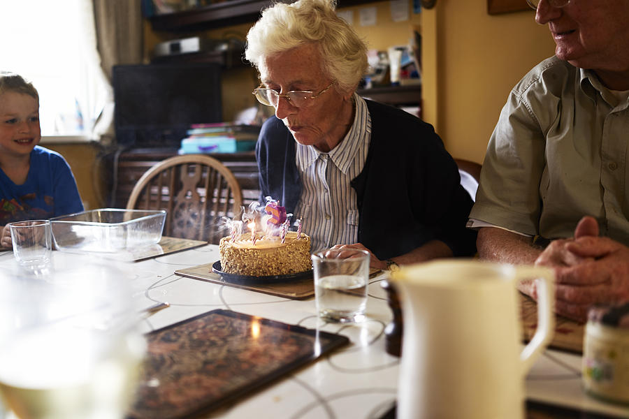 Elderly woman celebrating her birthday Photograph by Ballyscanlon