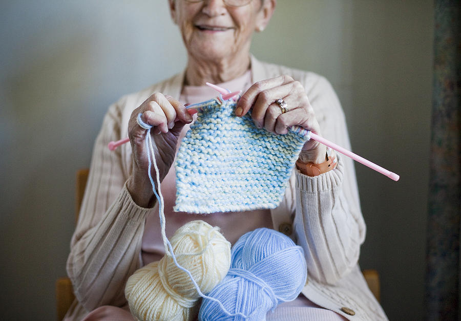 Elderly woman knitting scarf Photograph by Dimitri Otis