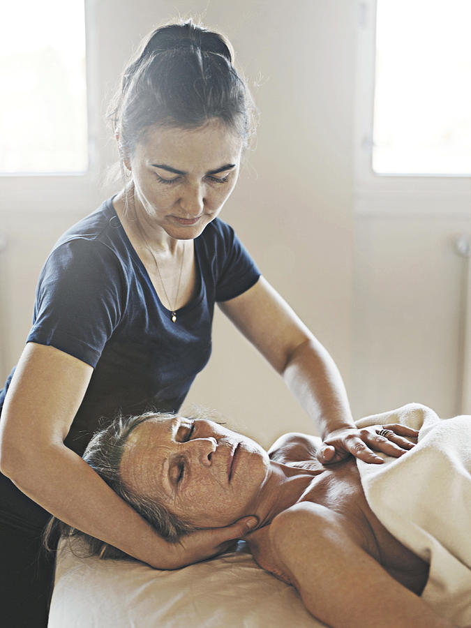 Elderly woman receiving healing massage. Photograph by David Trood