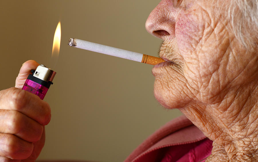 Elderly woman smoking Photograph by Gilbert Laurie