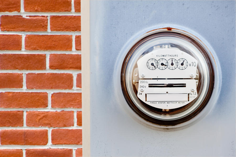 Electric meter on house Photograph by Pkline