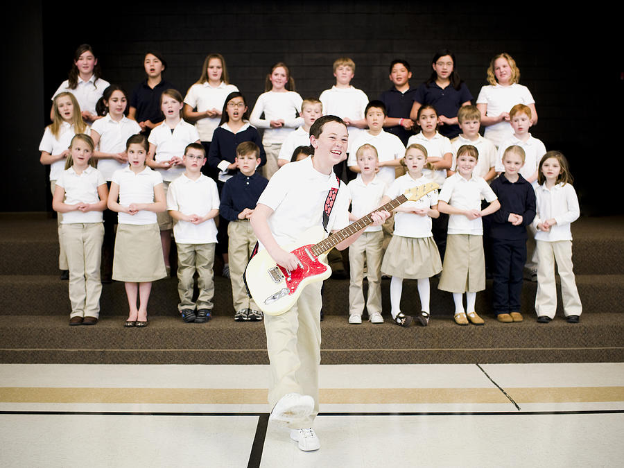 Elementary school children performing Photograph by Rubberball/Nicole Hill
