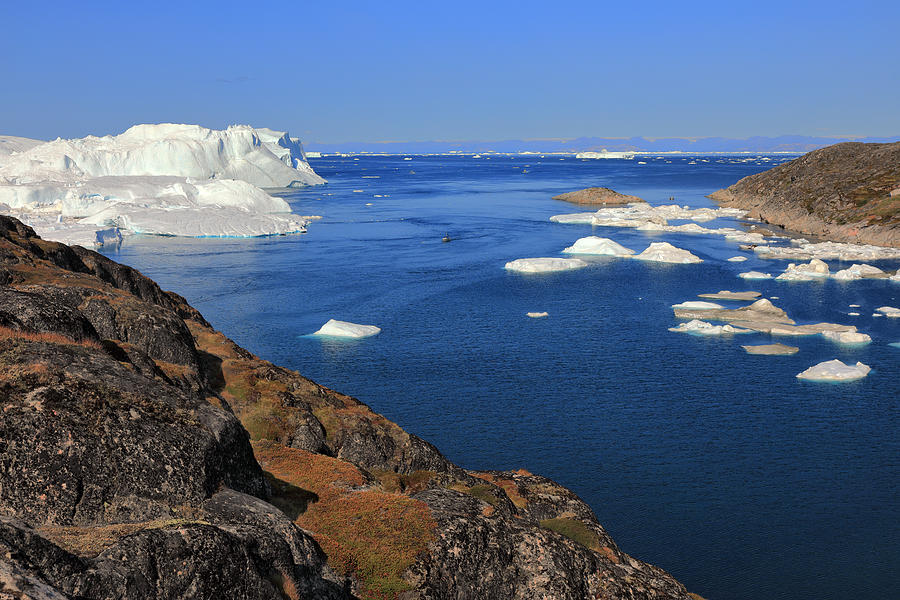 Elevated view from rocky terrain at huge icebergs Photograph by Rainer Grosskopf