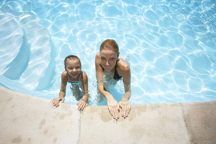 Elevated View of a Mother and Daughter in a Swimming Pool Photograph by Digital Vision.