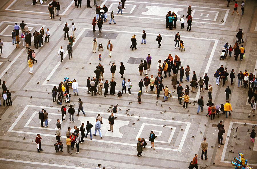 Elevated view of people walking in a square Photograph by Stockbyte