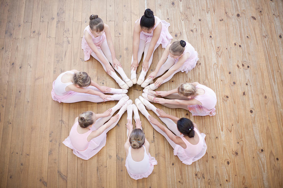 Elevated view of young ballerina group in circle Photograph by Zero Creatives