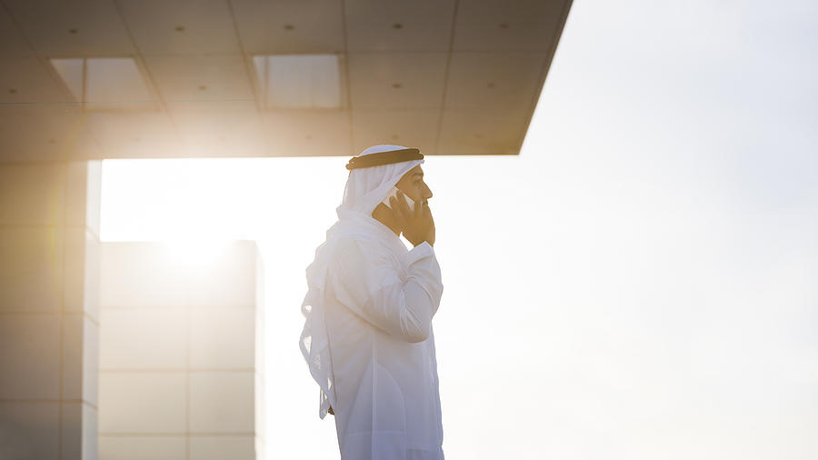 Emirati Businessman On A Rooftop In Evening Sunlight Photograph by Visualspace