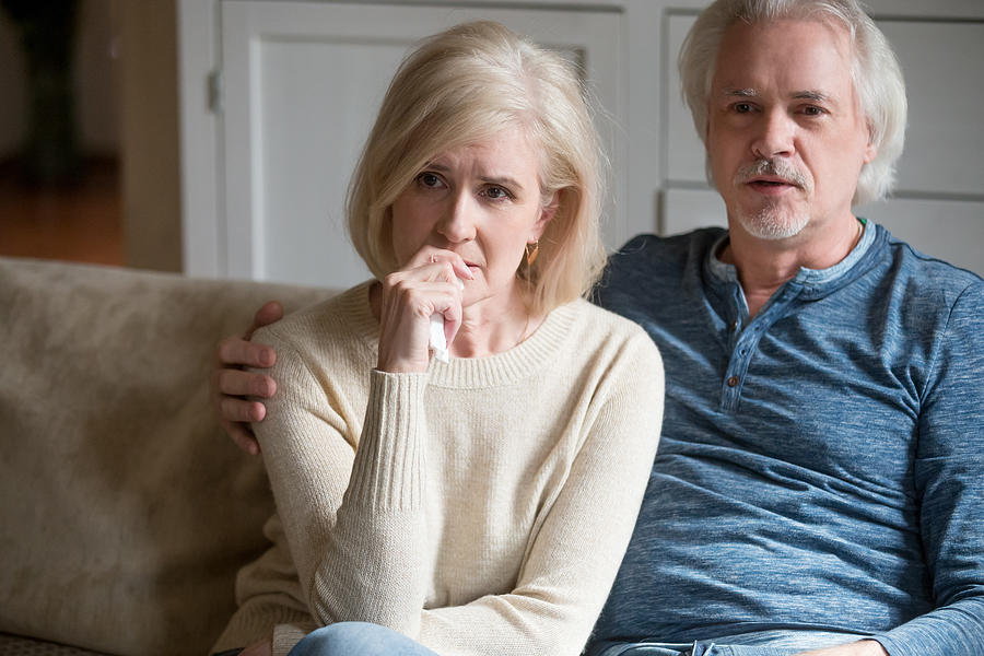Emotional senior couple get nervous watching TV drama at home Photograph by Fizkes