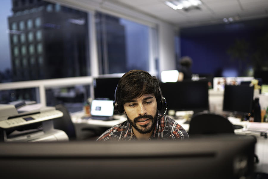 Employee working with headset in office callcenter Photograph by FG Trade